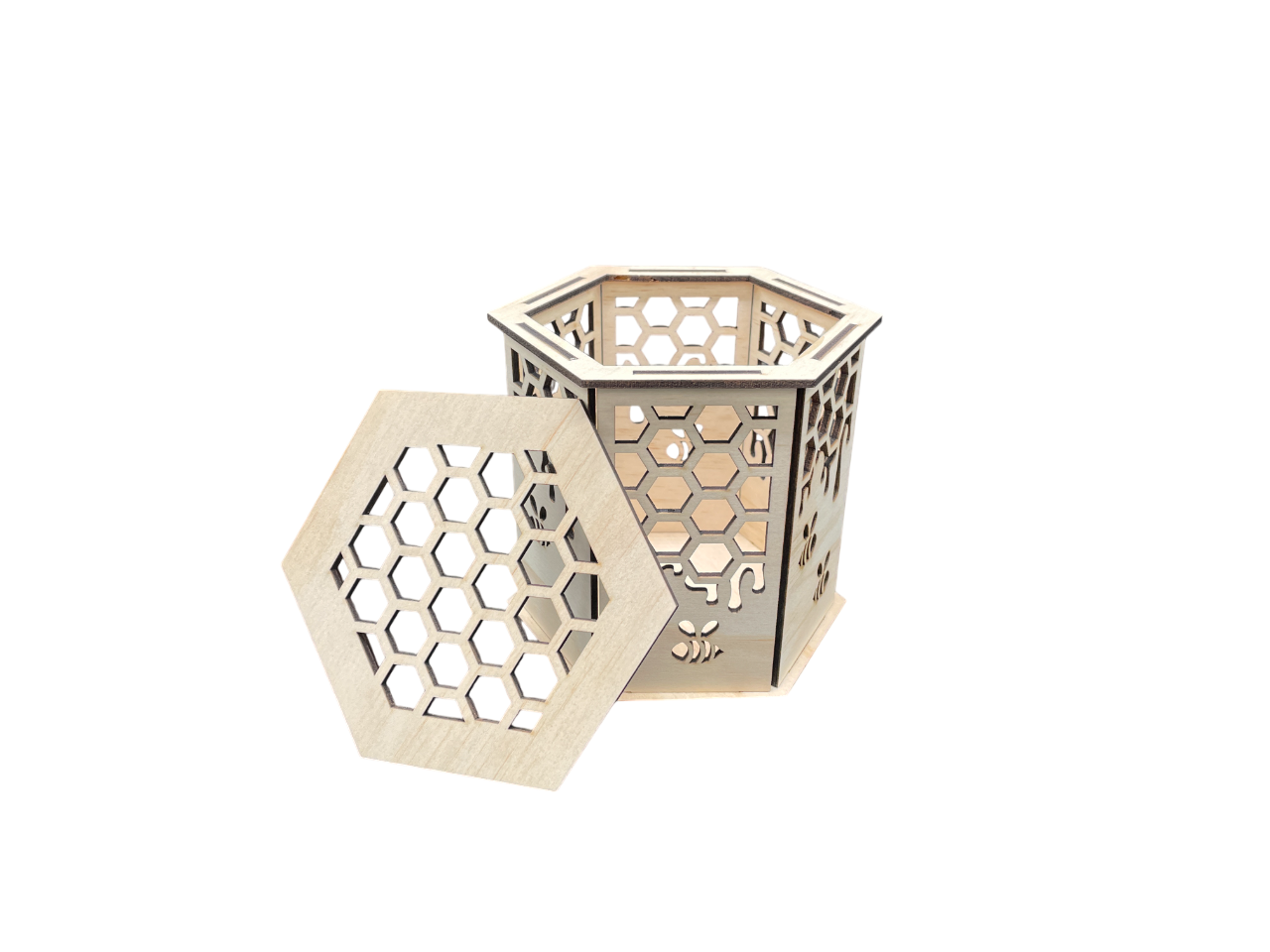 Laser-cut hexagon wooden gift box with honeycomb and bee pattern, lid removed, showing interior.