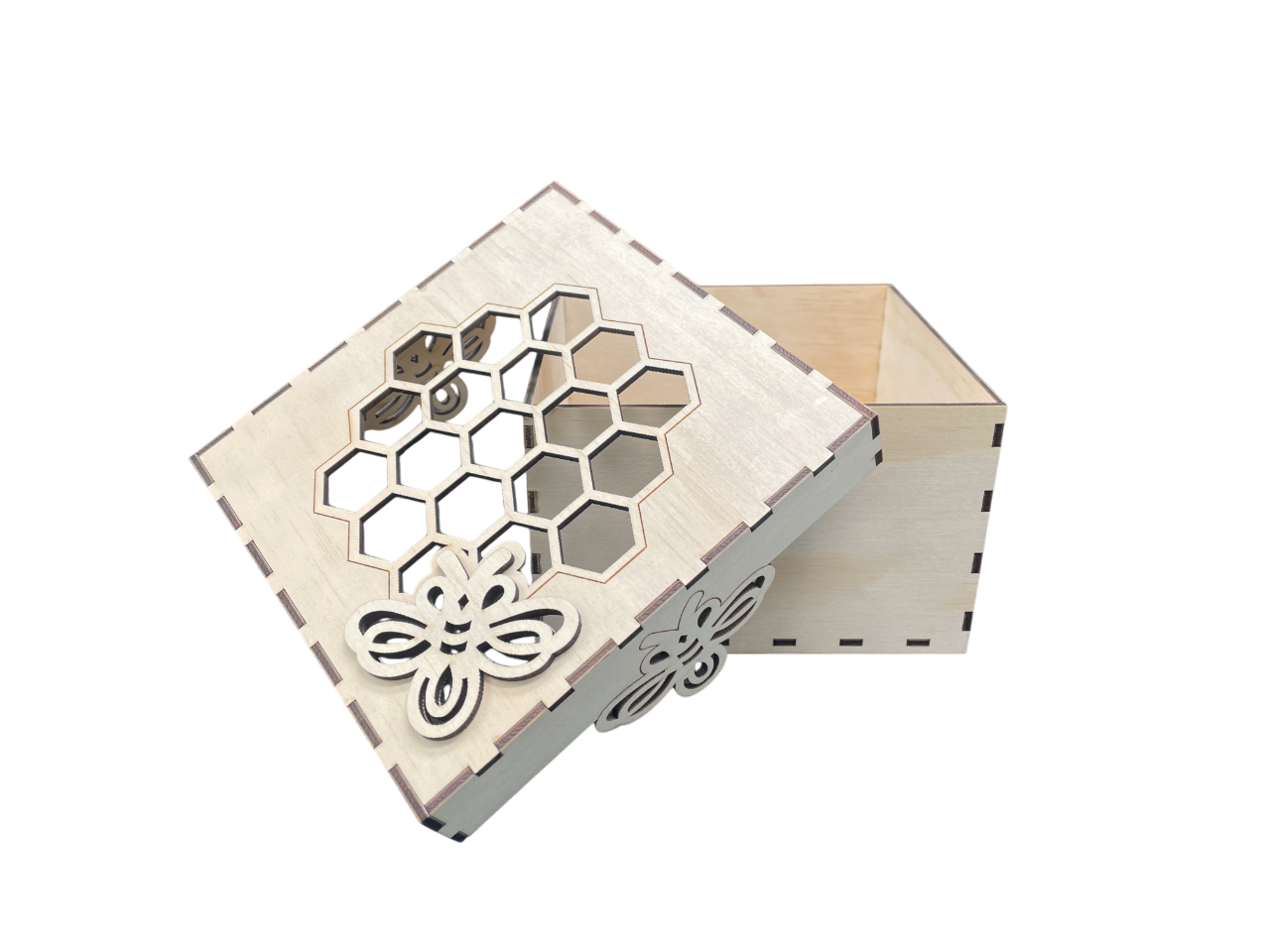 Close-up of bee and honeycomb detail on lid of laser-cut plywood gift box