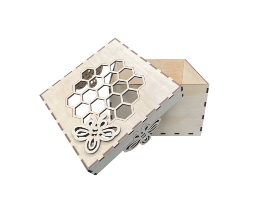 Close-up of bee and honeycomb detail on lid of laser-cut plywood gift box